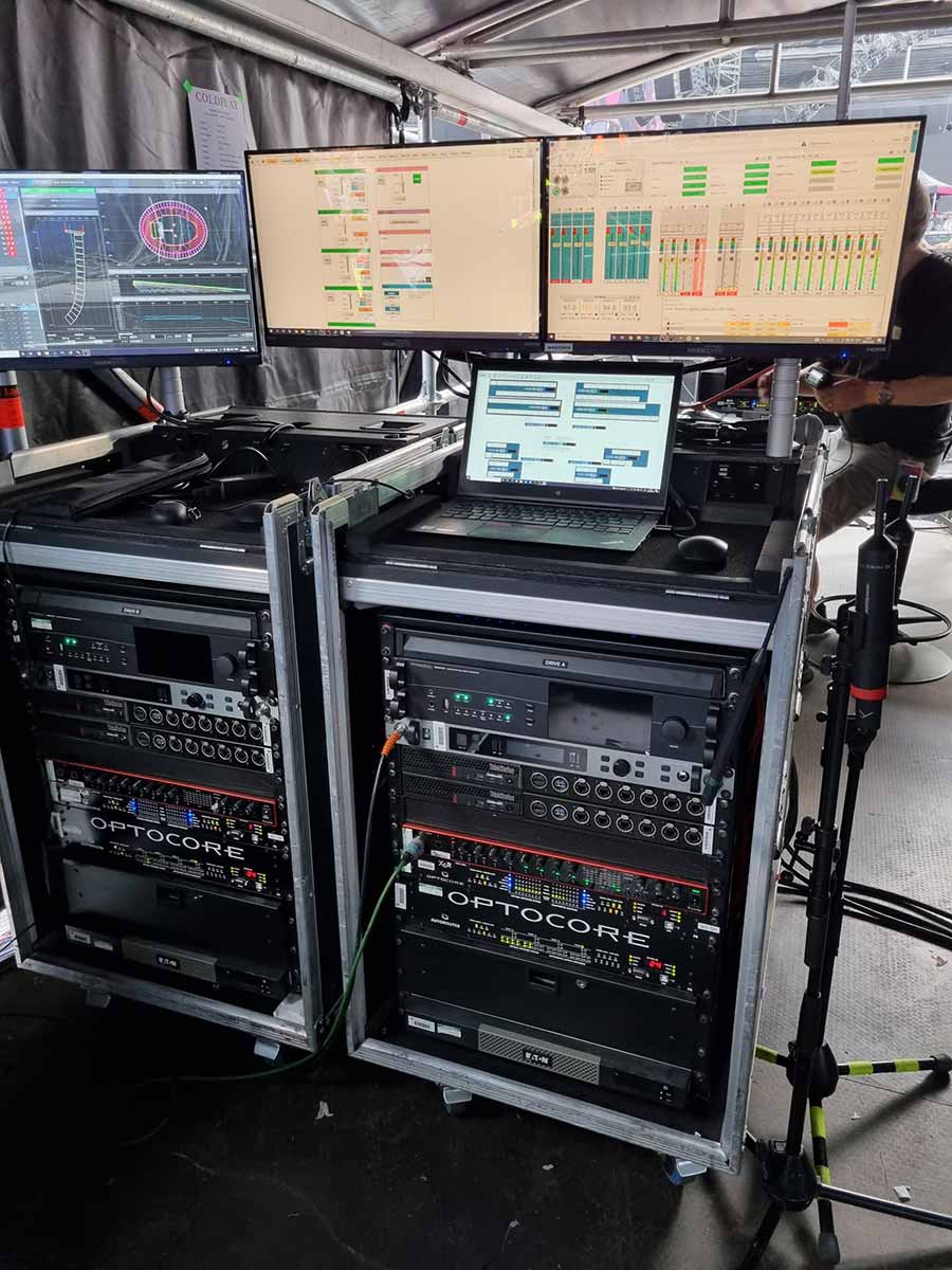 Racks of equipment backstage at a Coldplay concert, including two DirectOut Prodigys