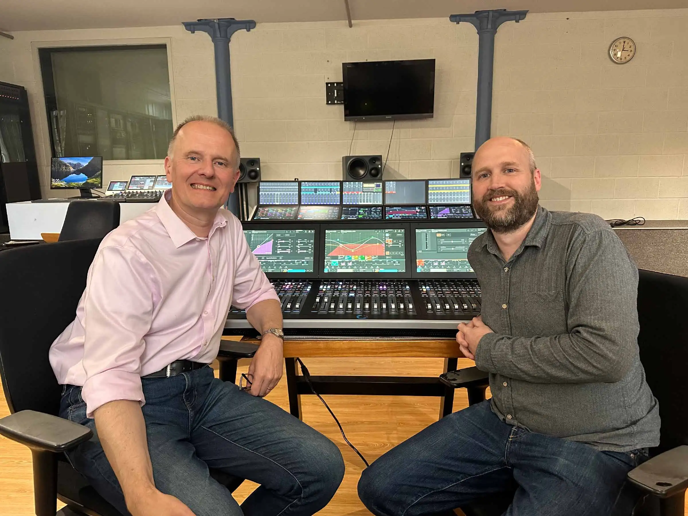 Martin Warr (Synthax) and Anthony Harrison (Calrec) in front of the Argo M 36-fader mixing console