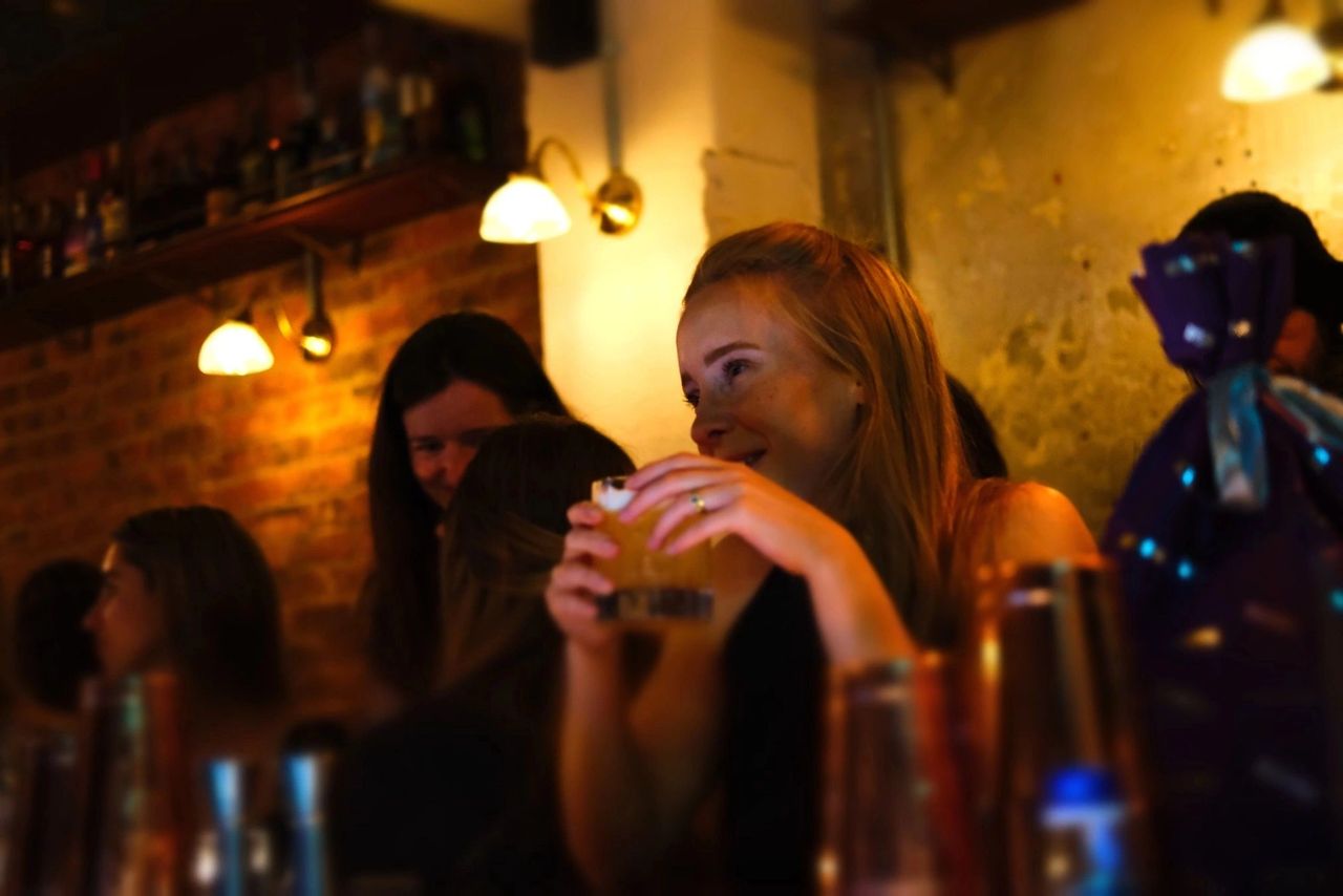 Woman holding a drink at the Thin White Duke (London)