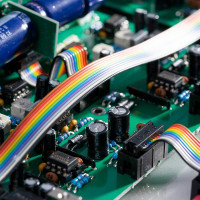 Rainbow-coloured ribbon cable on a green circuit board